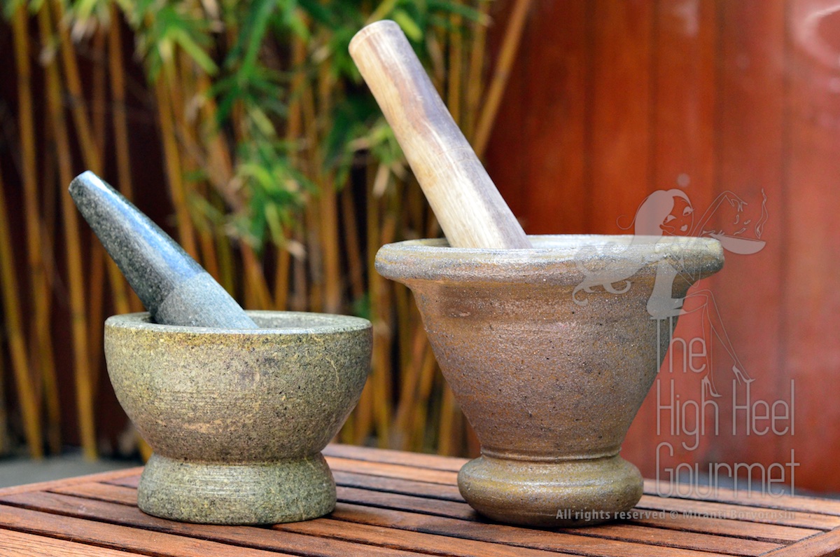 Left: The granite mortar with granite pestle. This is a must-have tool in every common Thai household. Even more so than a rice cooker, because we can cook rice in a regular pot but can't live without these. Right: The terra cotta mortar with wooden pestle. This is good for making "Som Tam" or papaya salad, NOT for curry paste. The pestle isn't heavy enough to grind the ingredients, and if you tried to pound them hard enough the mortar will break.