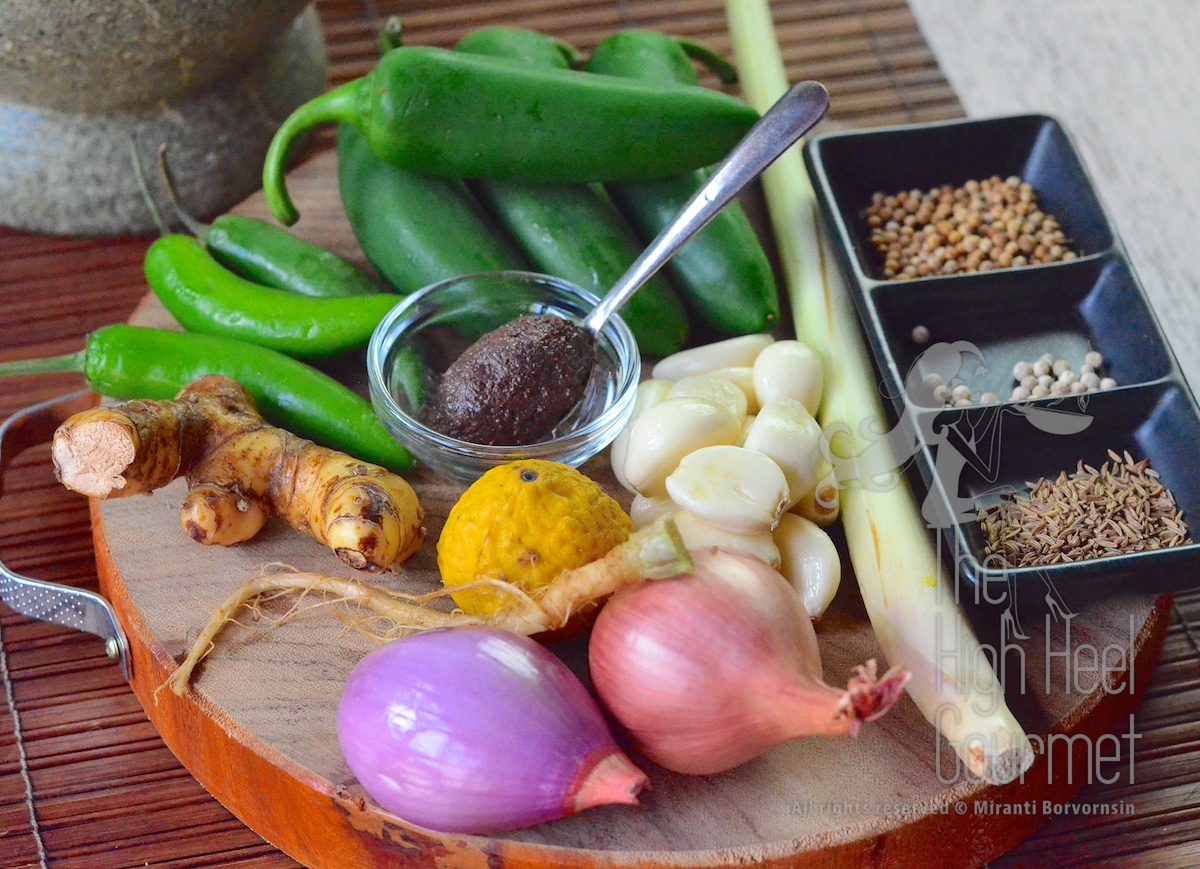 Clockwise from the center: Shrimp paste (in the glass cup), Garlic, Shallots, Coriander root, Kaffir lime (only the zest will be used), Galangal, Serrano chiles, Jalapeño chilies, Lemongrass, Coriander seed, White peppercorns, Cumin seeds