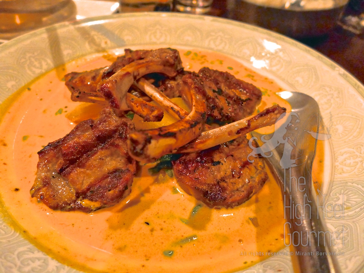 Wine marinated lamb popsicles in funugreek cream curry on turmeric and spinach potatoes